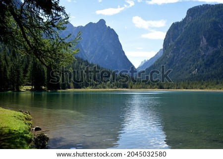 Lake Dobbiaco in the morning, a small alpine lake with clear and calm waters, an idyllic setting Royalty-Free Stock Photo #2045032580