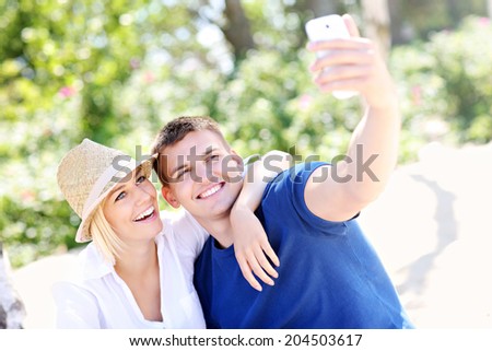 A picture of a young couple taking a picture of themselves at the beach