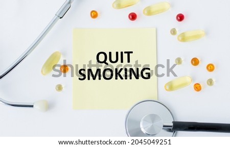 On the card, the text of quit SMOKING, next to the colored tablets.