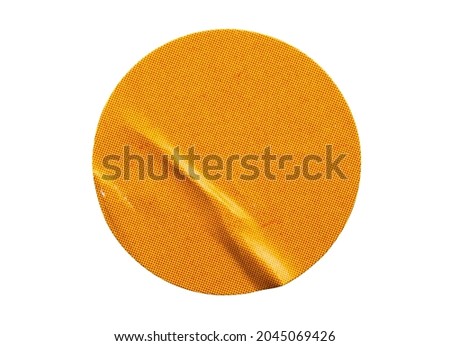 Blank orange round adhesive paper sticker label isolated on white background