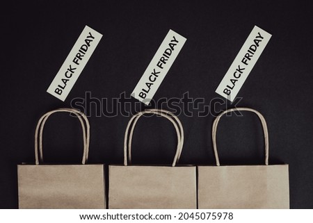 Three paper bags with black background and black Friday texts