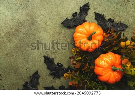 Happy Halloween swamp green background with pumpkins, bats with copy space