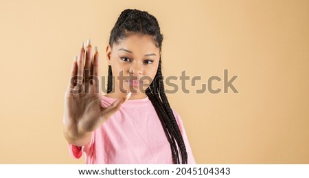 young african woman makes stop racism gesture