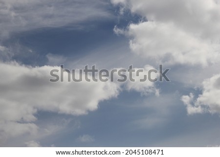 Background of fluffy clouds on a blue sky background
