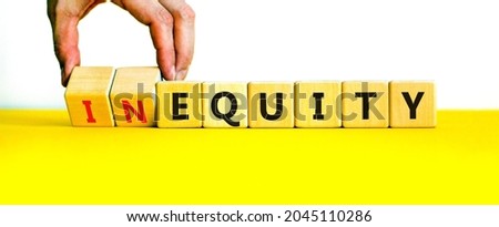 Inequity or equity symbol. Businessman turns wooden cubes and changes the word inequity to equity. Business and inequity or equity concept. Beautiful white background, copy space.