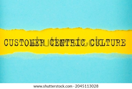 Customer centric culture text on torn paper , yellow background