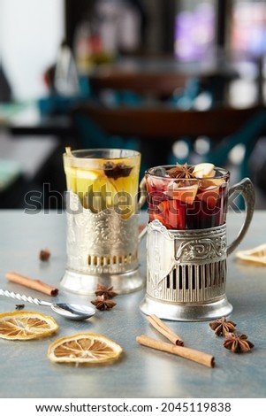 mulled wine in a glass on a wooden table. Decorated with dark, cinnamon and lemon