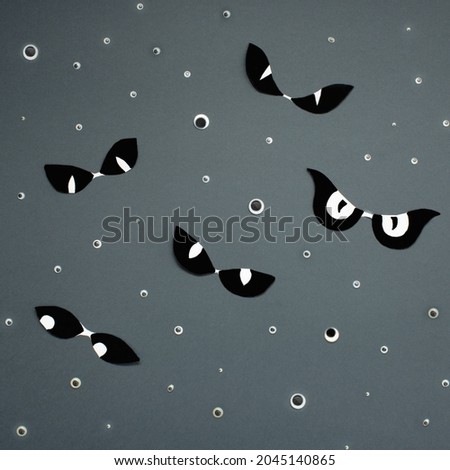 Spooky concept on gray background. Pattern made of eyes. Monochr