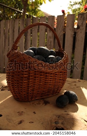 Fresh and delicious plums in a basket