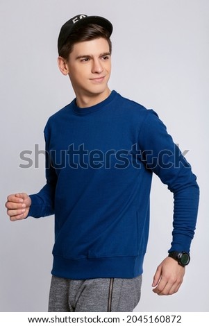 City portrait of handsome guy wearing Navy blue blank hoody or sweatshirt with space for your logo or design. Mockup for print
