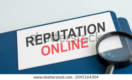 online reputation word on white paper card and magnifying lens