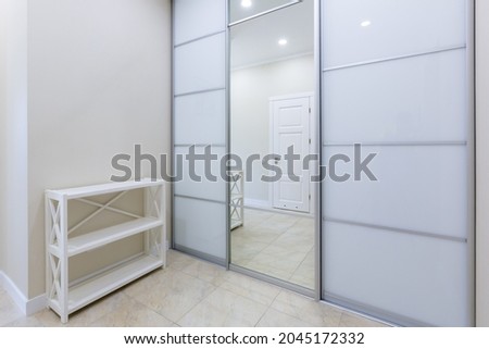 interior photo corridor entrance to the apartment with a large white closet