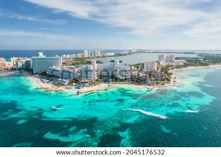Aerial panoramic view of Cancun beach and city hotel zone in Mexico. Caribbean coast landscape of Mexican resort with beach Playa Caracol and Kukulcan road. Riviera Maya in Quintana roo region on Royalty-Free Stock Photo #2045176532