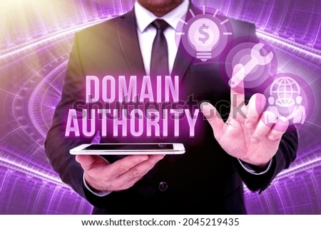 Text sign showing Domain Authority. Business idea calculated metric for how well a domain is likely to rank Man In Office Uniform Standing Pressing Virtual Button Holding Tablet. Royalty-Free Stock Photo #2045219435