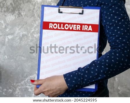 Business concept about ROLLOVER IRA with sign on the piece of paper. 
