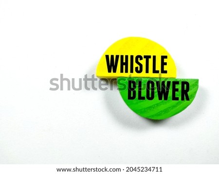 Text WHISTLE BLOWER writing on colored block on white background.