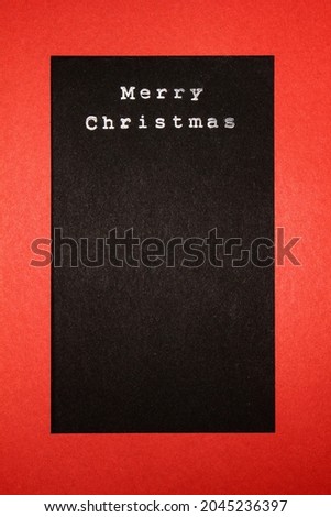 Black paper with "Merry Christmas" written on it