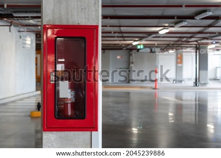Installed Fire Extinguisher on the Wall of the Parking Lot