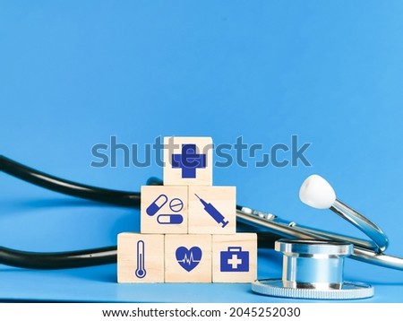 Wooden cubes with medical icons and stethescope. Concept of health care and medicine.