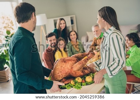 Portrait of attractive adorable cheery kind lovable big full family serving roasted turkey fresh garnish at home indoors