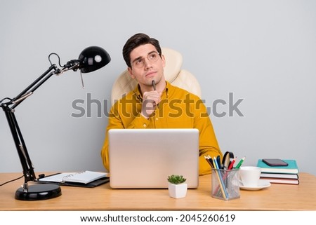 Portrait of attractive focused minded man using web writing article essay analyzing isolated over grey color background Royalty-Free Stock Photo #2045260619