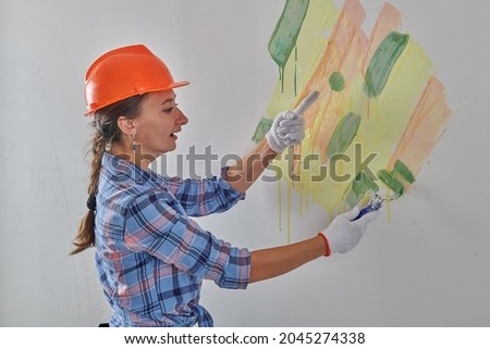 repairwoman looking for color on the wall