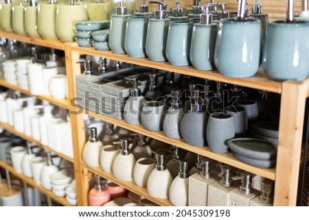 Soap dispensers, toilet brushes and toothbrush holders for sale in home furnishings store. Showcase with bathroom accessories Royalty-Free Stock Photo #2045309198