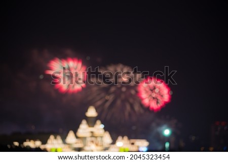 Fireworks over the castle, the effect of bokeh and blurring in the dark sky from the fireworks, an abstract dark background with lights.