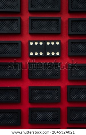 Domino minimalistic red and black background. Conceptual modern art design. Six by six is an open card. Gambling, mysterious flat background top view. Rectangular rows of dominoes. Abstract minimalism