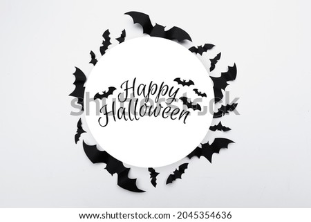 Halloween concept - paper bats on white background
