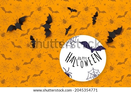 Halloween concept - paper bats on orange background