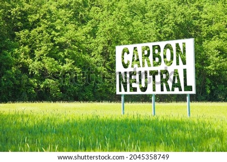 CO2 Carbon Neutral concept against an advertising billboard immersed in nature Royalty-Free Stock Photo #2045358749