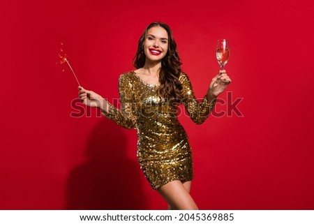 Photo of happy charming stunning woman hold hand christmas lights smile enjoy isolated on red color background