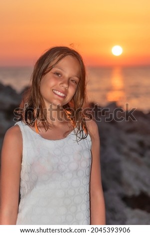 A nice girl on the beach at sunset