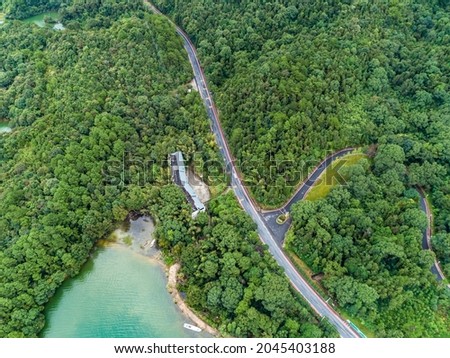 Aerial view of winding mountain road in forest