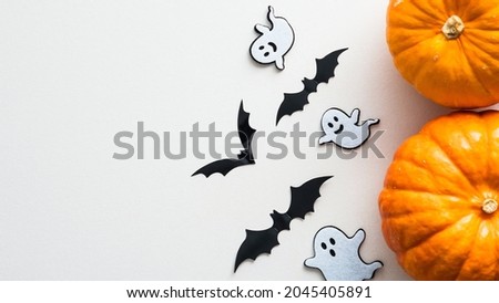 Happy Halloween banner design. Halloween decorations and pumpkins on white background. Flat lay, top view, copy space.