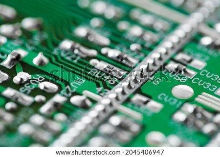 Printed electronic board with elements, green, close-up macro view, selective focus