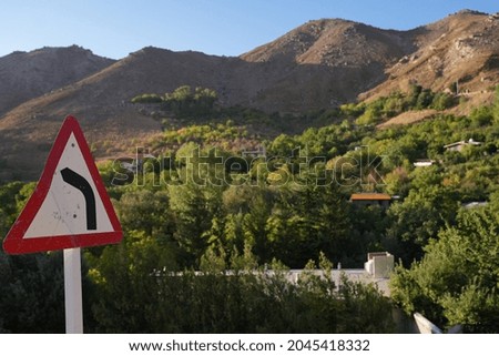 Mountainous nature and green trees And driving sign view 