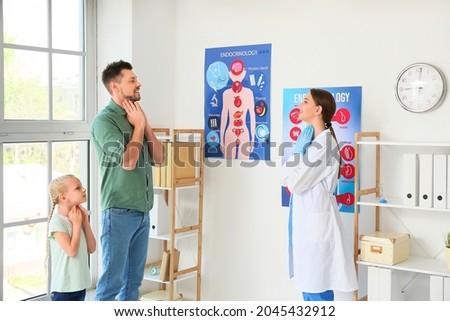 Father with daughter visiting endocrinologist in clinic
