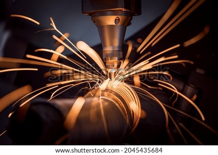 CNC Laser cutting of metal, modern industrial technology Making Industrial Details. The laser optics and CNC (computer numerical control) are used to direct the material or the laser beam generated. Royalty-Free Stock Photo #2045435684