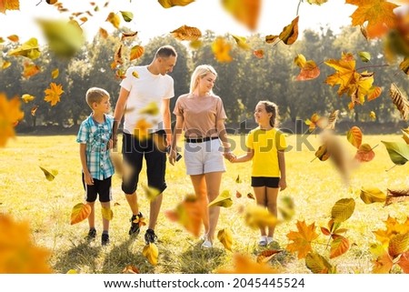 Picture of lovely family in autumn park, young parents with nice adorable kids playing outdoors, five cheerful person have fun on backyard in fall, happy family enjoy autumnal nature