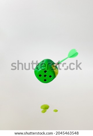 dice green with stabbed arrow.concept design.white background.flying object