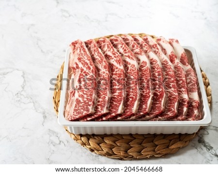 Raw ribs in packaging containers