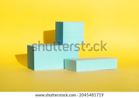 minimalist abstract background. three-dimensional geometric shapes in light blue on yellow background. Modern style, product podiums, art. Selective focus, space for text