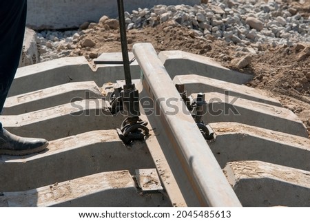 Railway construction. Rail mounts. The process of installing bolts for fastening a rail to a concrete sleeper. Royalty-Free Stock Photo #2045485613