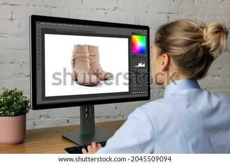 woman doing product photo editing on desktop computer in office