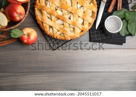 Delicious traditional apple pie on wooden table, flat lay. Space for text