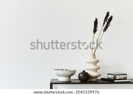 Stylish composition of minimalistic creative room interior with copy space, metal shelf and personal accesories. Black and white concept. Template.
