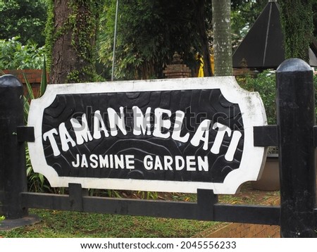 Signage of tourist attraction Jasmine Garden in the TMII area, Jakarta, with the shape of a dark wooden pole and white letters.
Photographed in Jakarta, September 2021