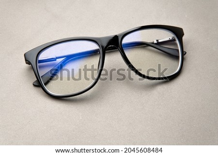 black frame blue light blocking technology anti glare spectacles glasses on grey background Royalty-Free Stock Photo #2045608484